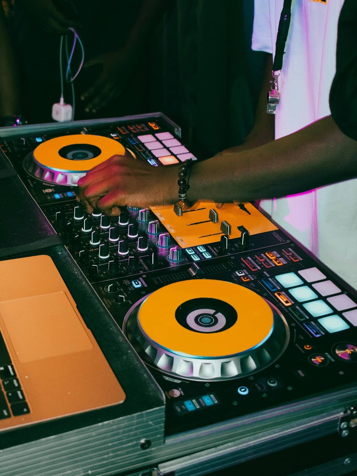 DJ's hands on a controller