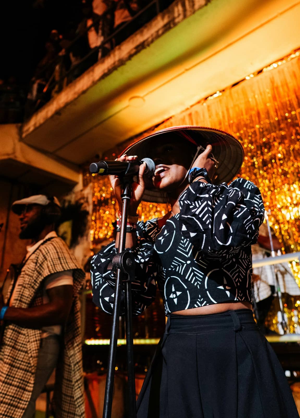 Singer performing on an amber-lit stage